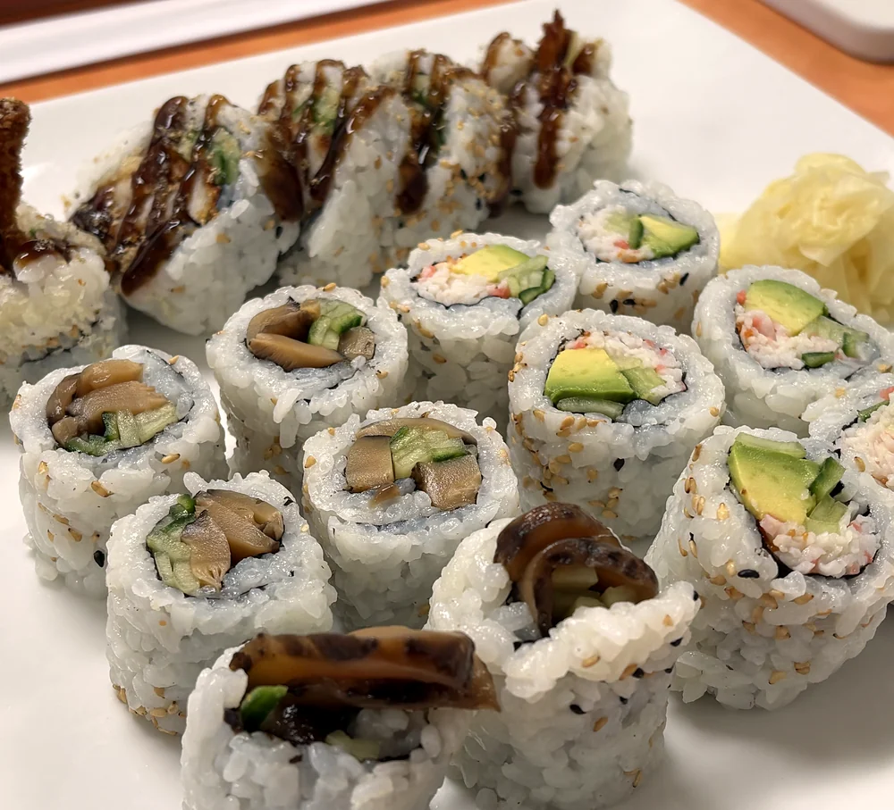Platter of sushi rolls: chicken teriyaki roll, California roll and mushroom rolls with pickled ginger at Hana Sushi, Winnipeg